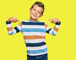 Adorable caucasian kid wearing casual clothes looking confident with smile on face, pointing oneself with fingers proud and happy.