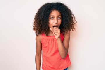 Fototapeta na wymiar African american child with curly hair wearing casual clothes feeling unwell and coughing as symptom for cold or bronchitis. health care concept.