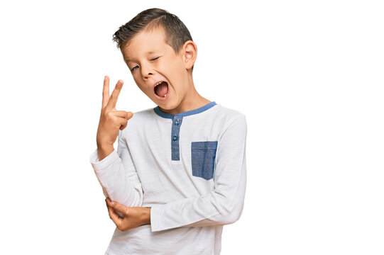 Adorable caucasian kid wearing casual clothes smiling with happy face winking at the camera doing victory sign. number two.