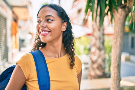 Young african american student girl smiling happy walking at university campus.
