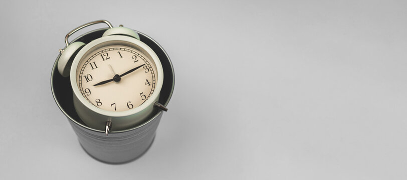 Take care about yout time concept, alarm clock in trash bin banner, copy space