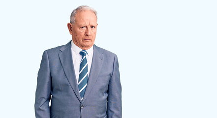 Senior handsome grey-haired man wearing elegant suit skeptic and nervous, frowning upset because of problem. negative person.
