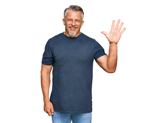 Middle age grey-haired man wearing casual clothes showing and pointing up with fingers number five while smiling confident and happy.