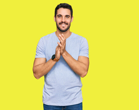 Young hispanic man wearing casual clothes clapping and applauding happy and joyful, smiling proud hands together