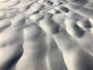 wind created wavy lines and traces across the sand 