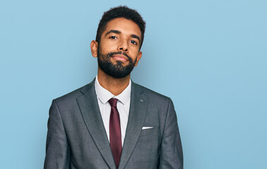 Young african american man wearing business clothes relaxed with serious expression on face. simple and natural looking at the camera.