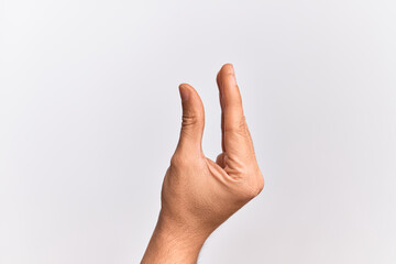 Hand of caucasian young man showing fingers over isolated white background picking and taking invisible thing, holding object with fingers showing space