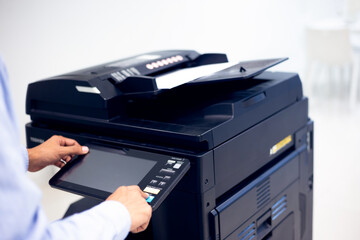 Bussiness man Hand press button on panel of printer, printer scanner laser in office copy machine supplies start concept.