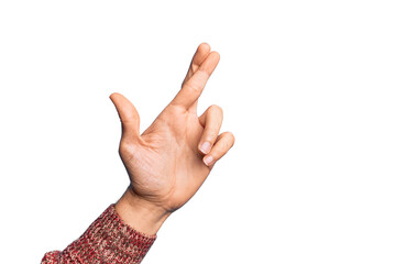 Naklejka premium Hand of caucasian young man showing fingers over isolated white background gesturing fingers crossed, superstition and lucky gesture, lucky and hope expression