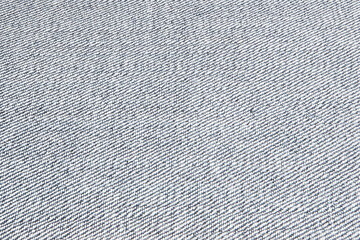 Fragment of a piece of denim close-up. The texture of the fabric.