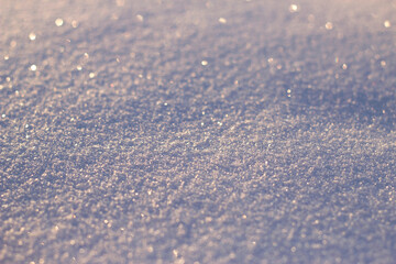 Clean fresh snow background with sunlight and glittering crystals - close up, winter background