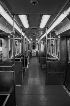 Black and white symmetrical picture of a train. Interior photo of a train car. Empty subway car in bnw.  Grunge grainy picture of a subway.