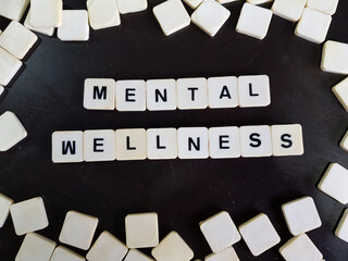 Mental health and wellness concept using alphabet tiles