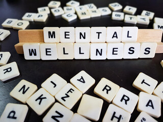 Mental health and wellness concept using alphabet tiles