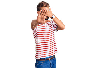Fototapeta premium Handsome blond man with beard wearing casual clothes and glasses covering eyes with hands and doing stop gesture with sad and fear expression. embarrassed and negative concept.