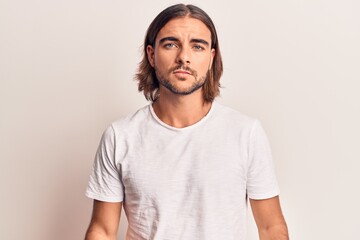 Young handsome man wearing casual clothes with serious expression on face. simple and natural...
