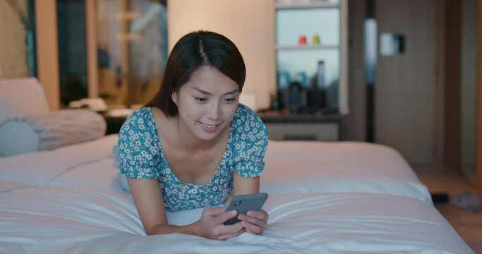 Woman use smart phone and lying on bed