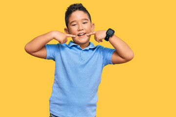 Little boy hispanic kid wearing casual clothes smiling cheerful showing and pointing with fingers teeth and mouth. dental health concept.