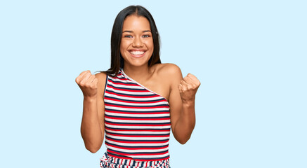 Beautiful hispanic woman wearing casual clothes celebrating surprised and amazed for success with arms raised and open eyes. winner concept.