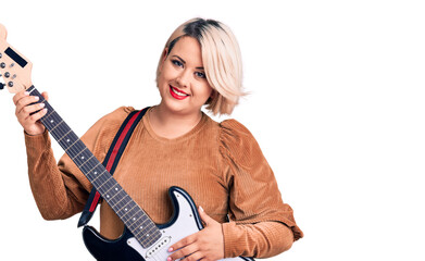 Young blonde plus size woman playing electric guitar looking positive and happy standing and smiling with a confident smile showing teeth