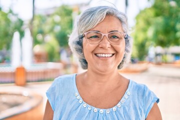 Fototapeta premium Middle age woman with grey hair smiling happy outdoors