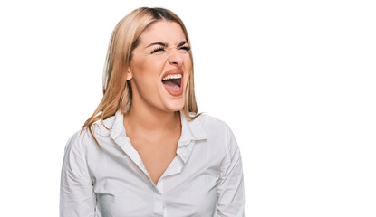 Young caucasian woman wearing casual clothes angry and mad screaming frustrated and furious, shouting with anger. rage and aggressive concept.