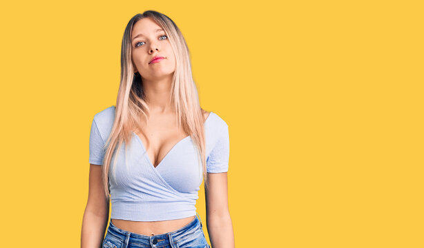 Young beautiful blonde woman wearing casual clothes relaxed with serious expression on face. simple and natural looking at the camera.