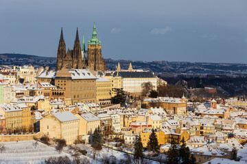 Snowy Prague City with gothic Castle from Hill Petrin in the sunny Day, Czech republic