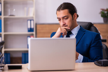 Young male employee working in the office