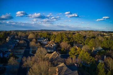 Aerial view of an upscale subdivision in suburbs shot during golden hour