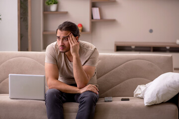 Young male freelancer working at home