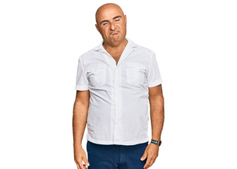 Fototapeta premium Mature middle east man with mustache wearing casual white shirt looking sleepy and tired, exhausted for fatigue and hangover, lazy eyes in the morning.