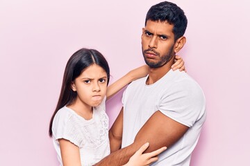 Young father and daughter wearing casual clothes skeptic and nervous, disapproving expression on face with crossed arms. negative person.