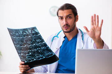 Young male doctor radiologist working in the clinic