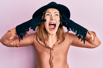 Young caucasian woman wearing barber apron angry and mad screaming frustrated and furious, shouting...