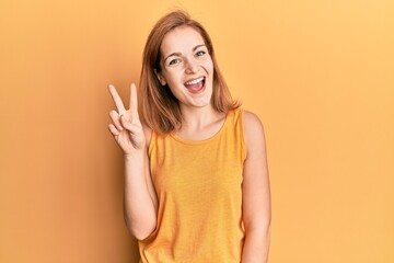 Young caucasian woman wearing casual style with sleeveless shirt showing and pointing up with...