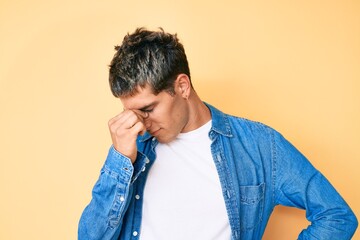 Young handsome man wearing casual clothes tired rubbing nose and eyes feeling fatigue and headache. stress and frustration concept.