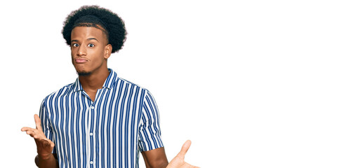 African american man with afro hair wearing casual clothes clueless and confused expression with...