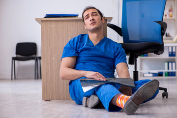 Young male doctor radiologist being unhappy after night shift
