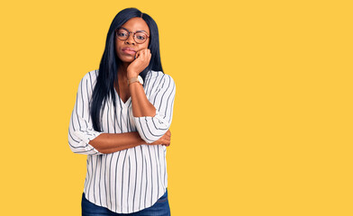 Young african american woman wearing casual clothes and glasses thinking looking tired and bored with depression problems with crossed arms.