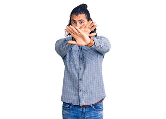 Young arab man wearing casual clothes rejection expression crossing arms and palms doing negative sign, angry face