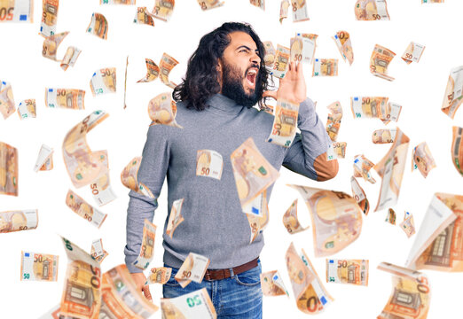 Young arab man wearing casual clothes shouting and screaming loud to side with hand on mouth. communication concept.