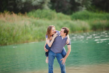 Young man woman on lake vacation. Couple funny spend time on river beach at sunny day, enjoying summer holidays. Summer lifestyle portrait of pretty young lovers. Vacation travel on weekend. Sea style