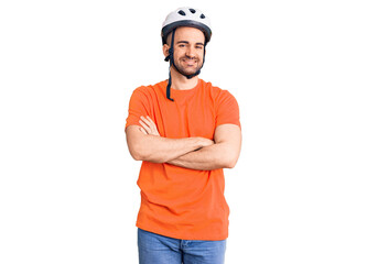 Young handsome man wearing bike helmet happy face smiling with crossed arms looking at the camera. positive person.