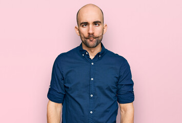 Young hispanic man wearing casual clothes making fish face with lips, crazy and comical gesture. funny expression.