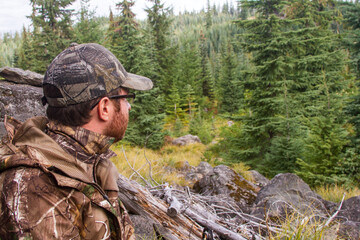 Fototapeta na wymiar Hunter sitting patiently in Oregon Cascade forest