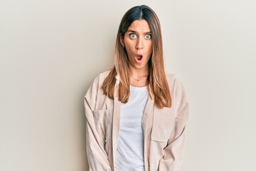 Obraz premium Brunette young woman wearing casual clothes afraid and shocked with surprise expression, fear and excited face.