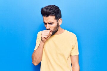 Young handsome man with beard wearing casual t-shirt feeling unwell and coughing as symptom for cold or bronchitis. health care concept.