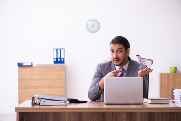 Young male employee in e-commerce concept