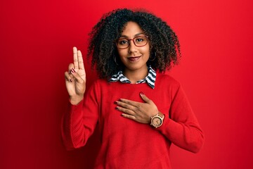 Beautiful african american woman with afro hair wearing sweater and glasses smiling swearing with...